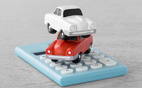 Photo Of Red and white toy cars on calculator.