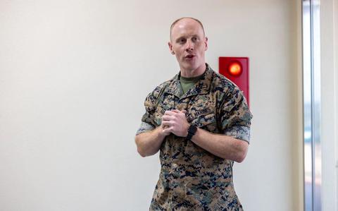 Photo Of U.S. Marine Corps Capt. Tyler C. Gunn, the Camp Schwab Operations Officer, speaks at a dedication ceremony on Camp Schwab, Okinawa, Japan, July 2, 2025. The ceremony is to recognize and honor Mr. Charles A. DeCasari, a retired U.S. Marine serving from 1984-2009 and then serving as the camp director for Camp Schwab from 2016-2024. Gunn is a native of California. 