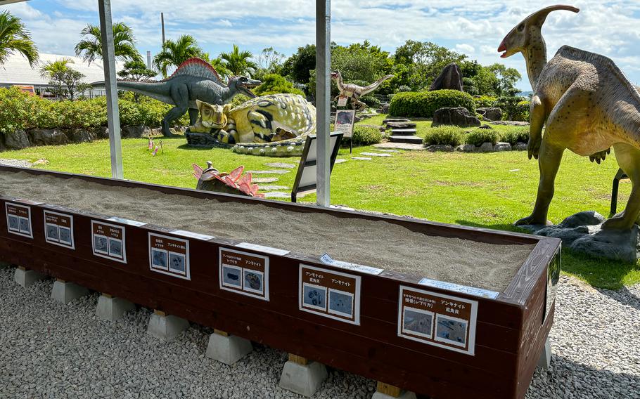 Some dinosaurs’ figures are situated outside.