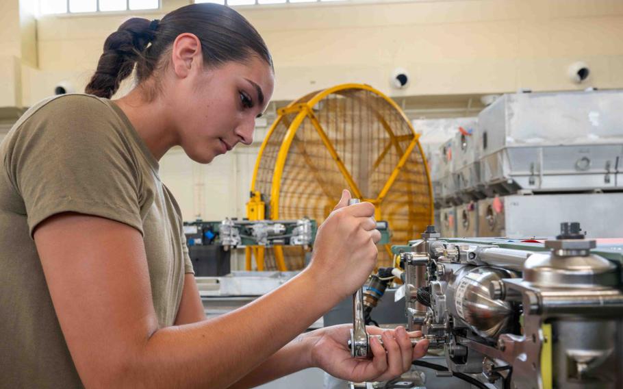 Airman 1st Class Emmaly Southworth turns a wrench while working on the BRU-61 munitions carriage system.