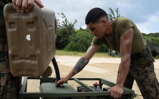 Photo Of U.S. Marine Corps Darwin Gutierrezmarte, a logistics specialist with Combat Logistics Battalion 31, the 31st Marine Expeditionary Unit, directs fuel into the motor of a light weight purification system during a combat support service area exercise, at Kin Blue Training Area, Okinawa, Japan, Aug. 10, 2024. The CSSA exercise utilized CLB-31 to create fresh water, maintain radio communications, and provide food, fuel, and fire support to sustain Battalion Landing Team 1/4 as the 31st MEU’s ground combat element. The 31st MEU, the Marine Corps’ only continuously forward-deployed MEU, provides a flexible and lethal force, ready to perform a wide range of military operations as the premiere crisis response force in the Indo-Pacific region. Gutierrezmarte is a native of New York.