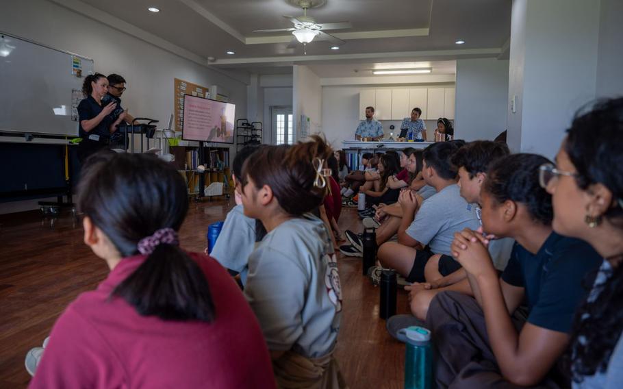 Students of Hope International Academy listen to Air Force Office of Special Investigations Detachment 624 agents brief students on cyberspace safety