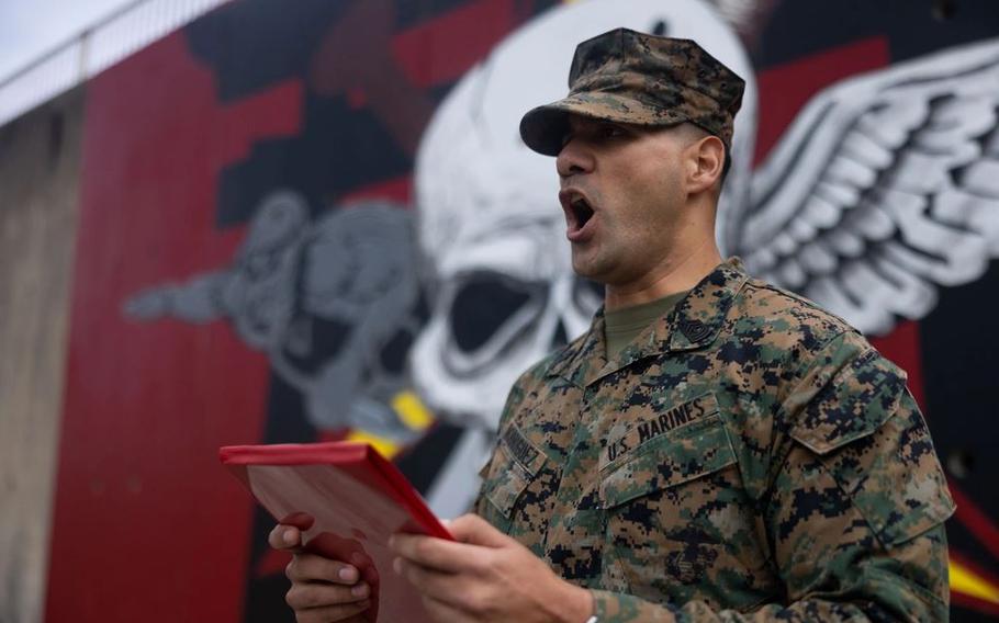 U.S. Marine Corps 1st Sgt. Roberto Rodriguez reads a promotion warrant.