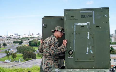 Photo Of U.S. Marine Corps Pfc. Robert Johnson inspects a generator at Kadena Air Base.
