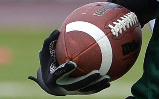 Photo Of a man holding a football.