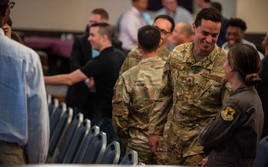 U.S. Air Force service members and civilians greet each other during a Career Summit panel at Kadena Air Base, Japan, Feb. 29, 2024. The panel provided service members and civilians information towards financial success, career opportunities , and advice from industry representatives.