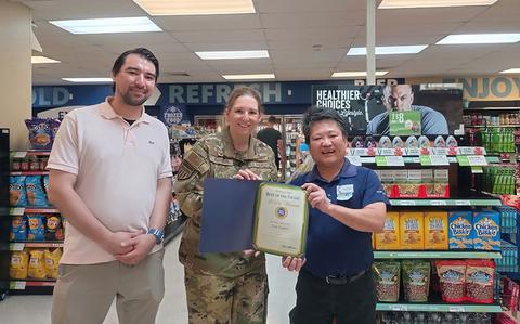 Photo Of Lt Col Hoffman and a Torii Express staff member are holding 2024 Best of the Pacific winner certificate. Mr. Tanaka is beside them.