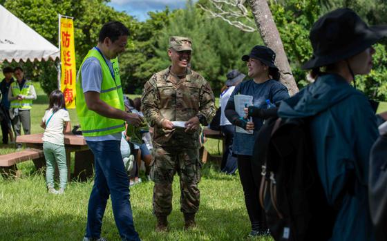 Photo Of From left, Chatan Town Mayor Masashi Toguchi, U.S. Air Force Col. Robinson Mata, 18th Mission Support Group commander, and Aoi Miyagi, 18th Wing community engagement specialist, talk to each other after completing a tsunami evacuation drill at Kadena Air Base, Japan, Sept. 7, 2024. Kadena Air Base leadership closely collaborated with local government officials, medical professionals, residents’ associations, wing planners, and community engagement personnel for the success of the exercise and preparedness for future challenges.