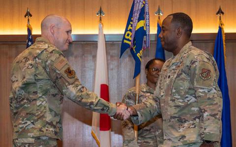 Photo Of U.S. Air Force Brig. Gen. Nicholas B. Evans, 18th Wing Commander, shakes hands with U.S. Air Force Lt. Col. Allen F. Dismuke Jr., 18th Comptroller Squadron incoming commander.
