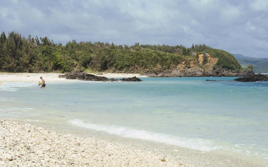 A man with swimming wear enjoying the beach.