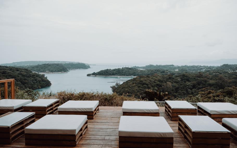 there are some chairs. the scenery from the hill can be enjoyed.