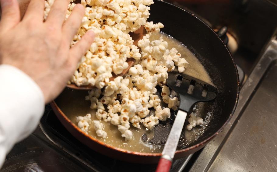 9 Add the popcorn back in the pan and mix them with the sauce quickly.