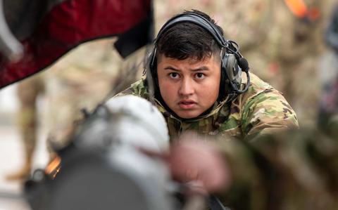 Photo Of  1st Class Saul Alvarado loads munitions onto a U.S. Air Force F-15C Eagle.