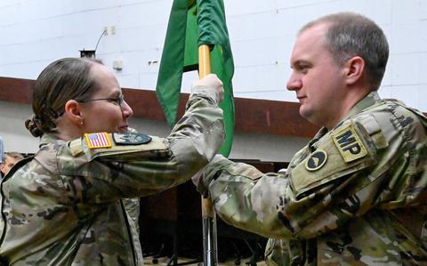 Photo Of U.S. Army Garrison Okinawa Lt. Col. Rachel Bowers, commander, passes the detachment guidon to Capt. Lawrence Jerichow, incoming 247th Military Police Detachment commander, during a change of command ceremony at Torii Station, Japan, May 13, 2025. Soldiers and leaders gathered to witness the symbolic transfer of authority.