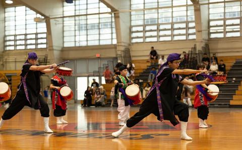 Photo Of Shimedaiko drummers with Firebird Drummers Eisa Group, perform during a Mother’s Day Eisa event on Camp Foster, Okinawa, Japan, May 11, 2025. The performance was held in honor of Mother’s Day and featured Eisa, a traditional Okinawan folk dance that involves singing, dancing and chanting while wearing colorful costumes and interacting with the community.
