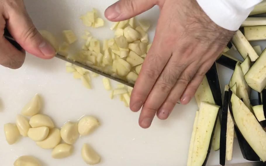 Cutting garlic.