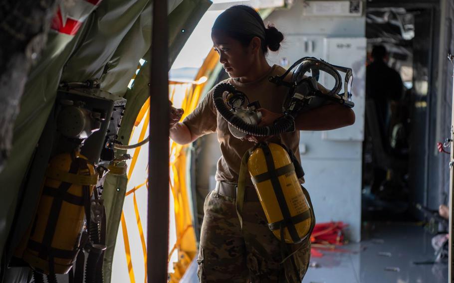 U.S. Air Force Capt. Hosana Terrado, 18 Aeromedical Evacuation Squadron flight nurse, secures an oxygen tank before takeoff at Kadena Air Base, Japan, Feb. 1, 2024. The 18th AES mission is to provide support for medical operations in wartime, during contingencies and for natural disaster relief operations that occur within the Indo-Pacific theater.