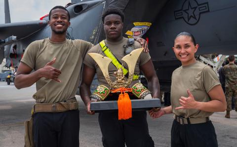 Photo Of From left, U.S. Air Force Senior Airman Semar Edwards, Senior Airman Fredarious Martin, 336th Fighter Generation Squadron load crew members, and Staff Sgt. Cierra-Nae Hanson, 336th FGS load crew chief, pose for a photo with an award after winning a quarterly load competition hosted by the 18th Maintenance Group at Kadena Air Base.