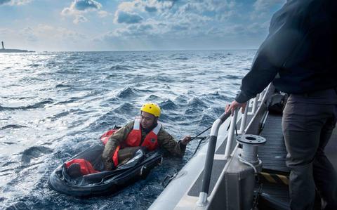 Photo Of U.S. Air Force Tech. Sgt. Daniel Ly, 18th Aeromedical Evacuation Squadron expeditionary communications technicians, prepares to get in position during exercise Shogun Shield off the coast of Okinawa, Japan, Dec. 4, 2024.