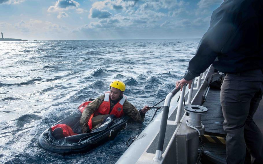 U.S. Air Force Tech. Sgt. Daniel Ly, 18th Aeromedical Evacuation Squadron expeditionary communications technicians, prepares to get in position during exercise Shogun Shield off the coast of Okinawa, Japan, Dec. 4, 2024.