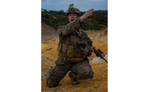 Photo Of U.S. Marine Corps Sgt. Lane Wilson, an infantry Marine with Battalion Landing Team 1/1, 31st Marine Expeditionary Unit, issues an order with a hand signal during a mechanized raid exercise at Camp Schwab, Okinawa, Japan, Feb. 16, 2024.