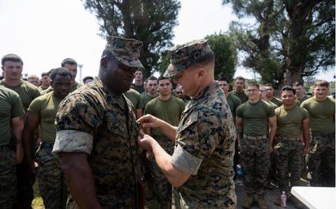 Photo Of U.S. Marine Corps Sgt. Maj. Ismael Bamba, left, is awarded the Navy and Marine Corps Commendation Medal by Col. Peter Eltringham, right, on Camp Hansen, Okinawa, Japan, April 11, 2024.