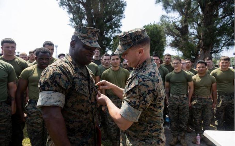 U.S. Marine Corps Sgt. Maj. Ismael Bamba, left, is awarded the Navy and Marine Corps Commendation Medal by Col. Peter Eltringham, right, on Camp Hansen, Okinawa, Japan, April 11, 2024. Bamba received the award for his heroic actions that saved the life of a Japanese national in Okinawa, Japan. The Navy and Marine Corps Commendation Medal is awarded to Marines and Sailors for meritorious service or acts of heroism. Bamba, a native of Ivory coast, West Africa, is the sergeant major and Eltringham, a native of Rhode Island, is the commanding officer, both with of 12th Marine Regiment, 3d Marine Division.