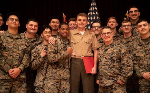 Photo Of U.S. Marine Corps Lance Cpl. Samuil Kays, center, an engineer equipment electrical systems technician with 7th Communications Battalion, III Marine Expeditionary Force Information Group, poses for a group photo after a naturalization ceremony on Camp Foster, Okinawa, Japan, March 5, 2024.