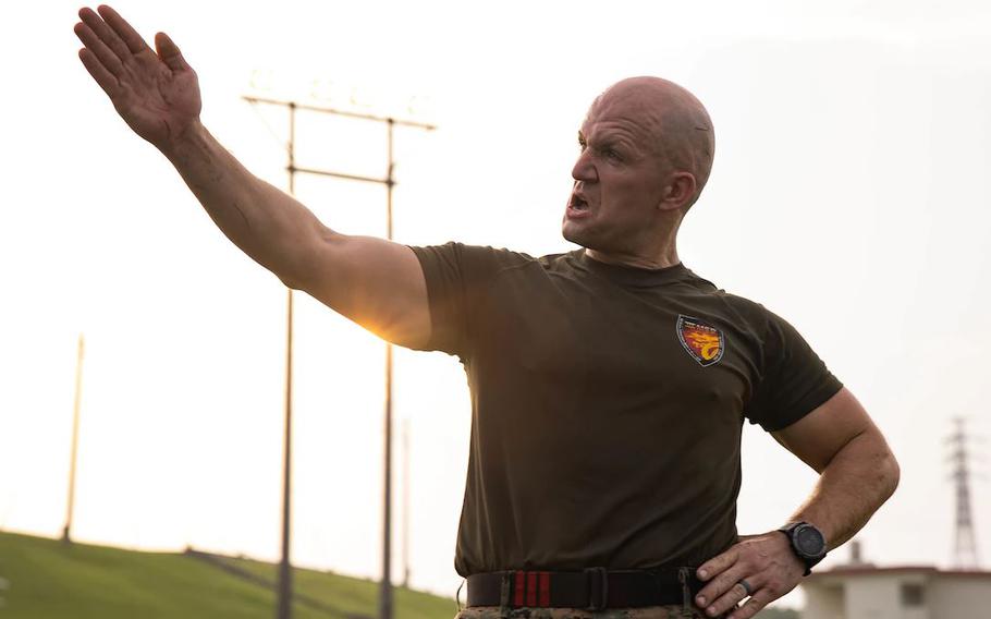 U.S. Marine Corps 1st Sgt. Daniel Best, company first sergeant of Headquarters Service Company, III Marine Expeditionary Force Support Battalion, III Marine Expeditionary Force, instructs Marines during a field meet on Camp Courtney, Okinawa, Japan, July 28, 2022. The Marines competed in various activities such as pull-ups, sprints, and fireman carries to boost camaraderie and morale in the unit. (Photo by Lance Cpl. Tyler)