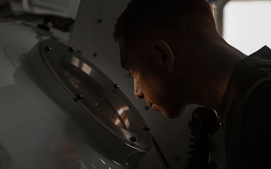 Petty Officer 1st Class Will Crampton, a first class navy diver with 3rd Reconnaissance Battalion, III Marine Expeditionary Force, monitors Marines inside a Standard Navy Double Lock Hyperbaric Recompression Chamber at Camp Schwab, Okinawa, Japan, Jan. 9, 2019. Crampton observed the Marines to ensure their safety while in a SNDLRCS during a training scenario to simulate the pressure felt when diving up to 60 feet in order to enhance combat readiness.