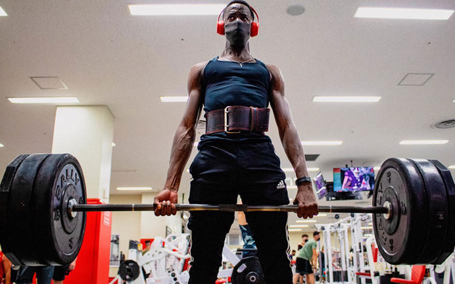 U.S. Marine Corps Pfc. Benjamin Crayton, a motor vehicle operator with Headquarters and Support Battalion, Marine Corps Installations Pacific, conducts a barbell deadlift on Camp Foster, Okinawa, Japan, Jan. 10, 2022. Crayton was born in Monrovia, Liberia during the First Liberian Civil War, and immigrated to Europe as a refugee. When he was 17 years old he moved to the U.S. and in 2021 he enlisted in the Marine Corps. (U.S. Marine Corps photo by Lance Cpl. Jonathan Beauchamp)