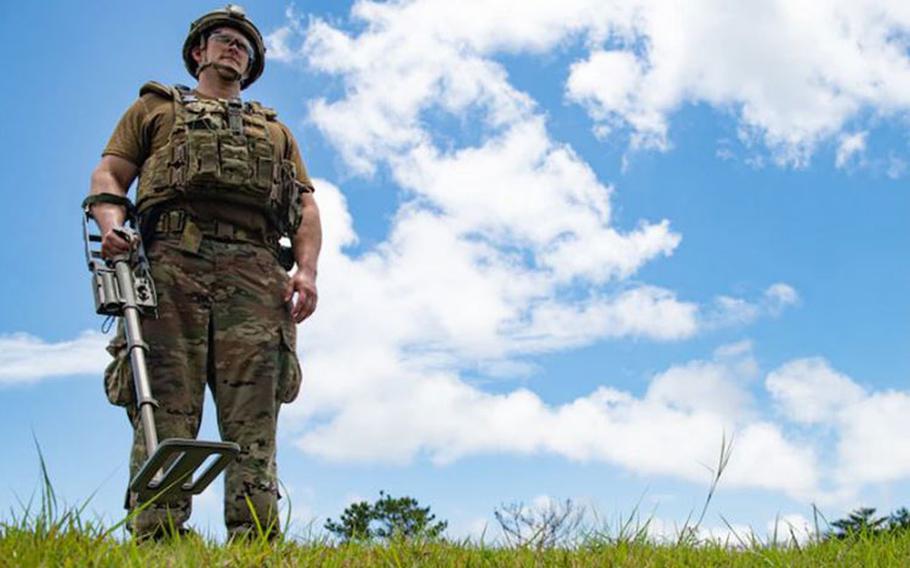 Tech. Sgt. Benjamin Dickson, an Explosive Ordnance Disposal technician from the 18th Civil Engineer Squadron, uses a metal detector during an Improvised Explosive Device training event on Kadena Air Base, Japan, May 26, 2021. Dickson used a metal detector after the IED had detonated, to conduct a post-blast assessment. (U.S. Air Force photo by Airman 1st Class Yosselin Perla)