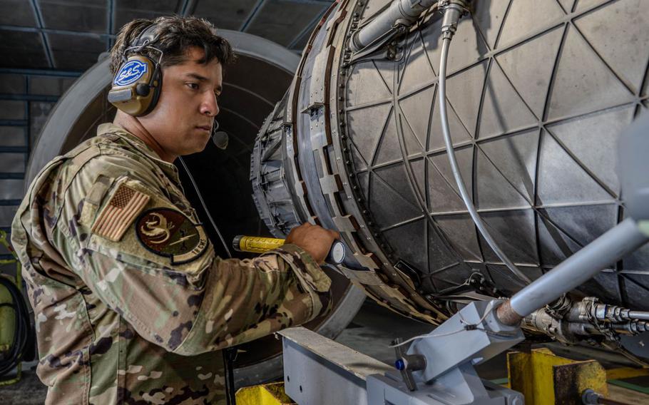 U.S. Air Force Staff Sgt. Ernesto Parra, 18th Component Maintenance Squadron test cell craftsman, inspects a F-15E Eagle engine, the F100-PW-220, during a routine afterburner test.