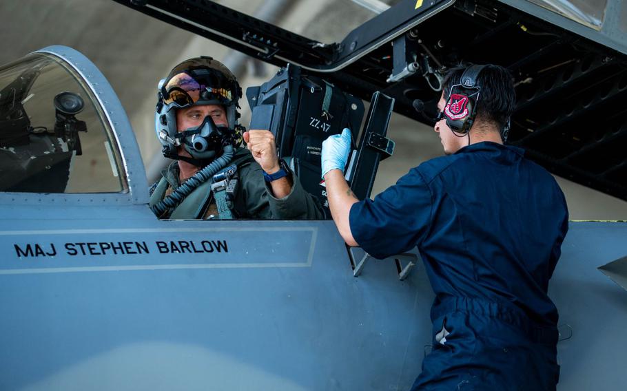 U.S. Air Force Maj. Peter Gawor, left, 67th Fighter Squadron director of operations, fist bumps Senior Airman Nicolas Stillman, 18th Aircraft Maintenance Squadron assistant dedicated crew chief, at Kadena Air Base, Japan, Aug. 15, 2024.