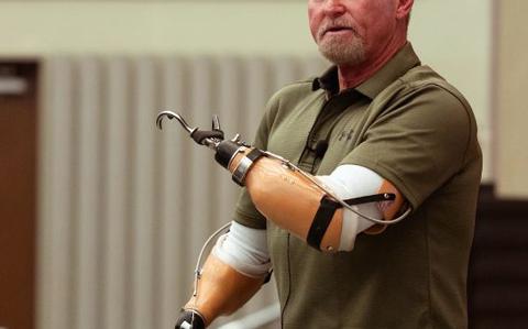 Photo Of Lee Shelby, motivational safety speaker, talks about how he lost both of his hands while working as an electrician during a presentation about occupational injuries, on Camp Foster, Okinawa, Japan, Feb. 8, 2023.