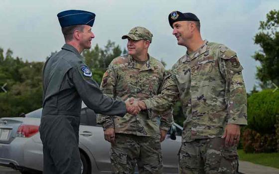 Photo Of U.S. Air Force Col. John Schutte, left, 5th Air Force deputy commander, greets Chief Master Sgt. Brandon Wolfgang, 18th Wing command chief, after arriving at Kadena Air Base, Japan, Oct. 2, 2024.