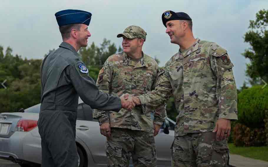 U.S. Air Force Col. John Schutte, left, 5th Air Force deputy commander, greets Chief Master Sgt. Brandon Wolfgang, 18th Wing command chief, after arriving at Kadena Air Base, Japan, Oct. 2, 2024.