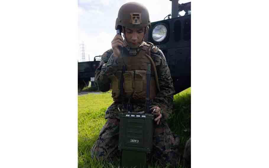 U.S. Marine Corps Lance Cpl. Zachary Gilman, a transmissions system operator with Marine Wing Communications Squadron 18, Marine Air Control Group 18, 1st Marine Aircraft Wing, conducts a radio check during unit level training.