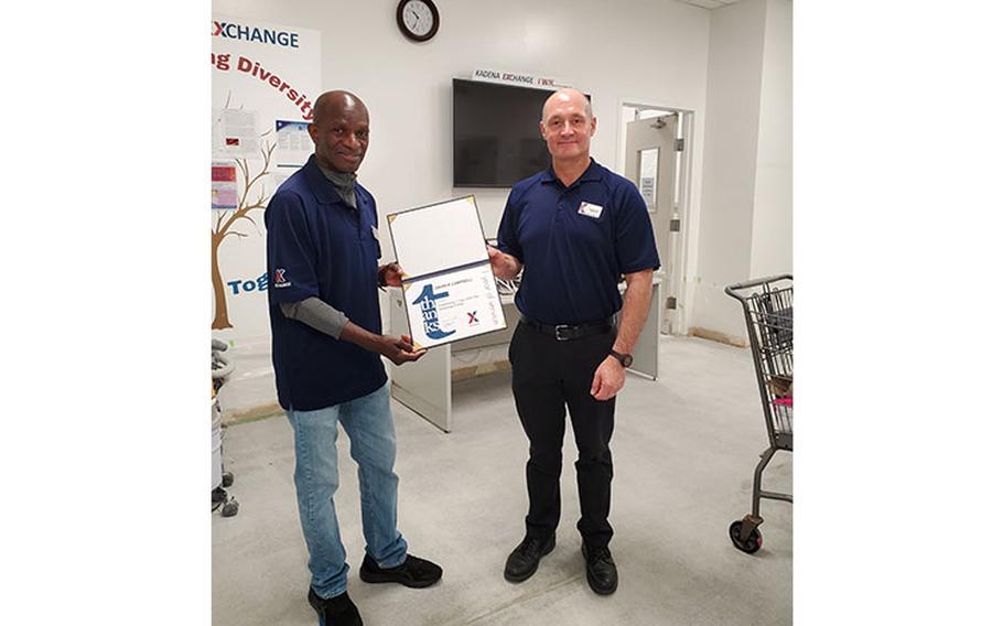 On April 1, David Campbell, Health and Beauty Care associate and Armando Moncayo-Pallares, Kadena main store sales and merchandise manager pose for a picture after Campbell received his one-year service award. Campbell, a native of California, is an Air Force veteran who served for more than 33 years.