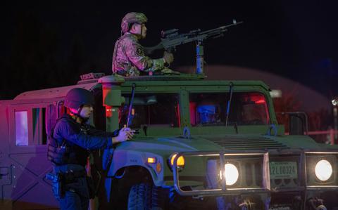 Photo Of U.S Air Force Senior Airman Christopher Vang, right, 18th Security Forces Squadron response force leader and Suguru Arakaki, 18th Security Forces Squadron civilian installation entry controller participate in a gate runner exercise as part of a base-wide routine readiness exercise.