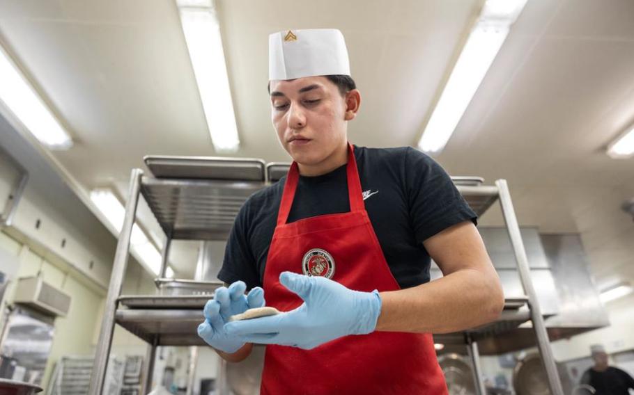 U.S. Marine Corps Cpl. Mauricio Nava Quintana, a food service specialist with Combat Logistics Regiment 37, 3rd Marine Logistics Group, prepares batter during the Chef of the Quarter competition at Camp Kinser, Okinawa, Japan, Feb. 8, 2024.