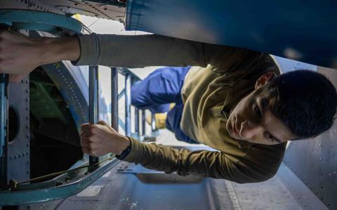 Photo Of U.S. Air Force Senior Airman Tristan Merritt, 82nd Reconnaissance Squadron electronic warfare journeyman, enters an RC-135 Rivet Joint at Kadena Air Base, Japan, Feb. 18, 2025.