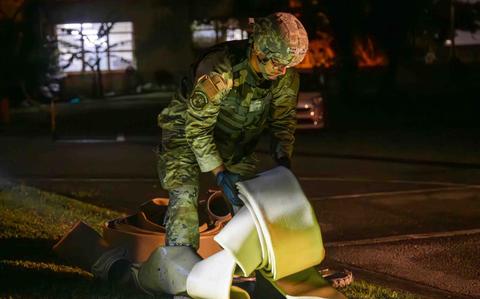 Photo Of U.S. Air Force Airman 1st Class Seth Boyer, 18th Civil Engineer Squadron water fuels maintenance system journeyman, unravels the water and fuel expedient repair system at Kadena Air Base, Japan.