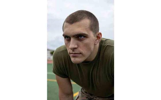 U.S. Marine Corps Sgt. Kaden Shin, a corrections specialist with Regional Brig, Marine Corps Installations Pacific, prepares for the tire flip event during the Pacific Iron Challenge on Camp Hansen.