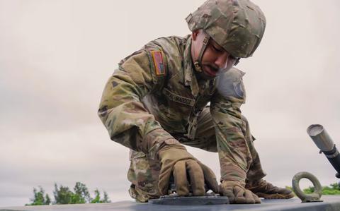 Photo Of U.S. Army Pfc. Da’Mario Deal-Maddox, 1-1 Air Defense Artillery vehicle driver, tightens a fuel cap on top of an M1097A2 electric power plant on Kadena Air Base, Japan.