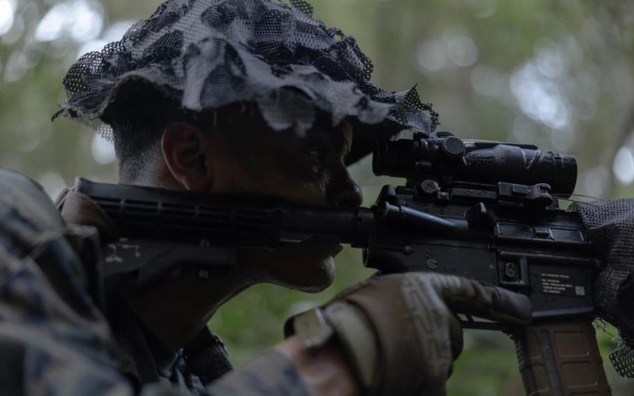 U.S. Marine Corps Lance Cpl. Angel Caldero, a fire support Marine with 5th Air Naval Gunfire Liaison Company, III Marine Expeditionary Force Information Group, posts security during Certification Exercise 24.3 at Camp Hansen, Okinawa, Japan, July 17, 2024. 