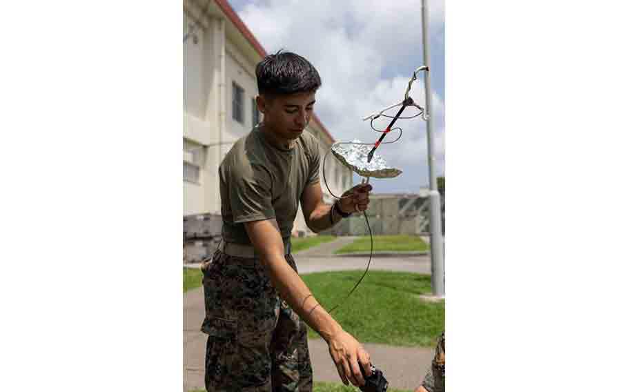U.S. Marine Corps Pfc. Bryan Chijate, a transmissions system operator with 5th Air Naval Gunfire Liaison Company, III Marine Expeditionary Force Information Group, tests a field expedient radio antenna on Camp Hansen, Japan.