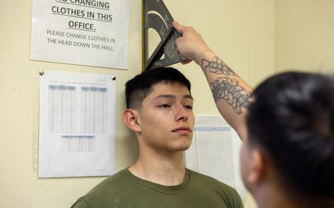 Photo Of U.S. Marine Corps Cpl. Kevin Dolino, a training clerk with S-3, Training, Plans, and Operations, Marine Corps Installations Pacific, records the height of Cpl. Osvaldo Hernandez, a postal clerk with Marine Corps Base Camp Butler Postal, during a height/weight measurement on Camp Foster, Okinawa.