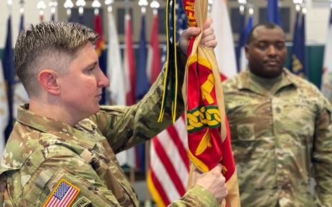 Photo Of U.S. Army Garrison Okinawa Lt. Col. Elizabeth Johnson, incoming commander, prepares to pass the garrison guidon during a Change of Command ceremony at Torii Station, Japan.