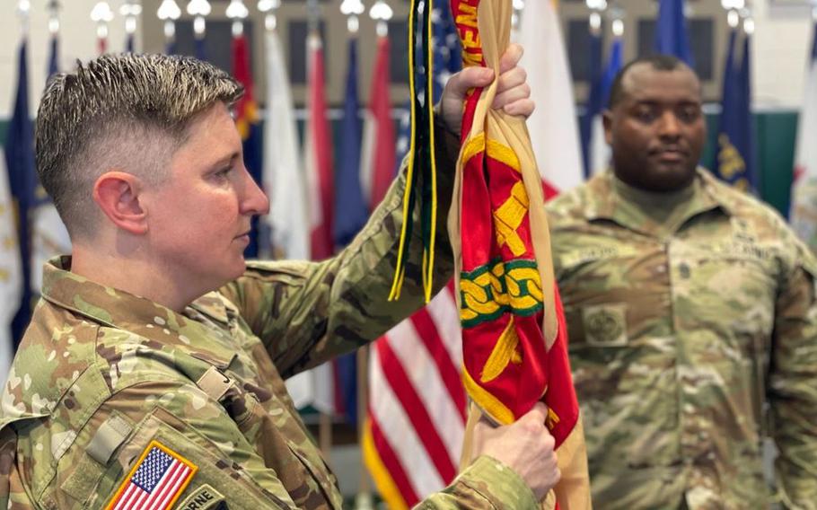 U.S. Army Garrison Okinawa Lt. Col. Elizabeth Johnson, incoming commander, prepares to pass the garrison guidon during a Change of Command ceremony at Torii Station.